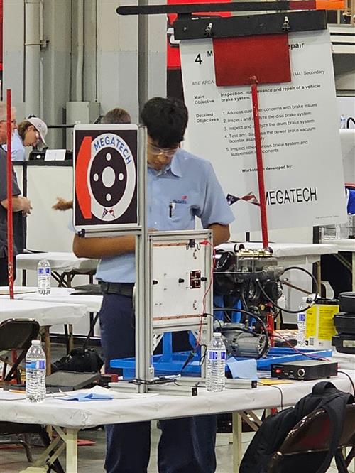 High school male working on an auto part
