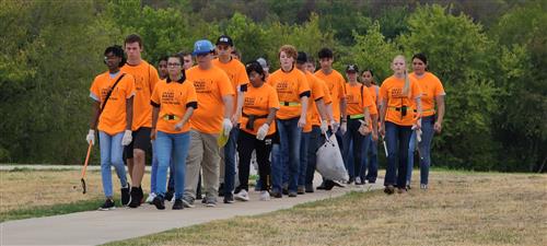 Students in orange shirts marching