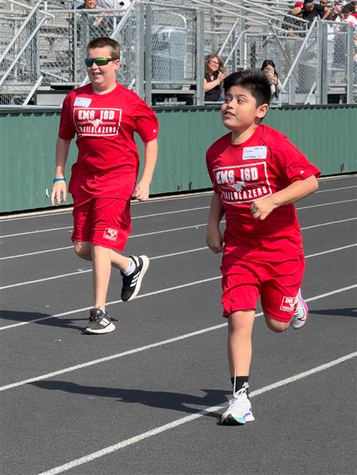 two boys run on a track