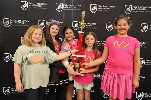 Five girls holding a trophy
