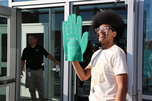 Eagle Mountain High Student greeting conference attendees