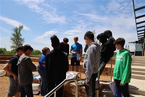 students look at a display outside