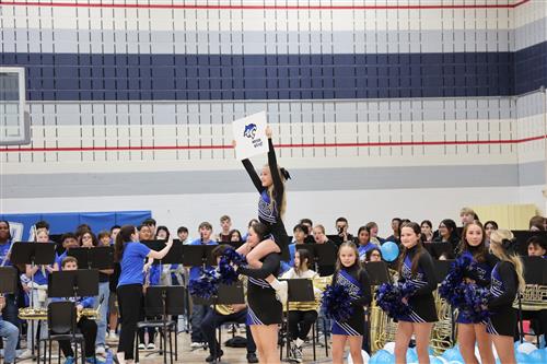 cheerleaders hold up a sign