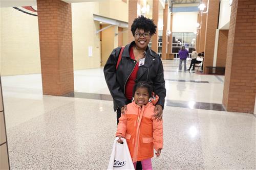 A woman stands with her daughter