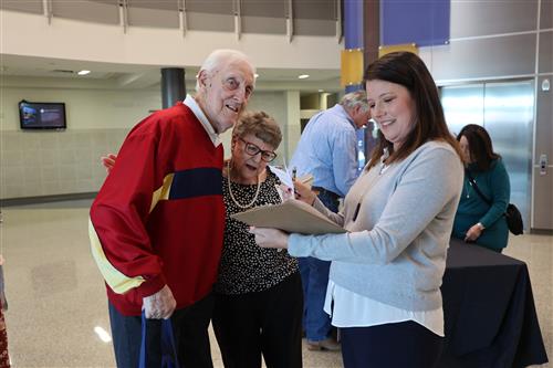 Three people looking at a folder