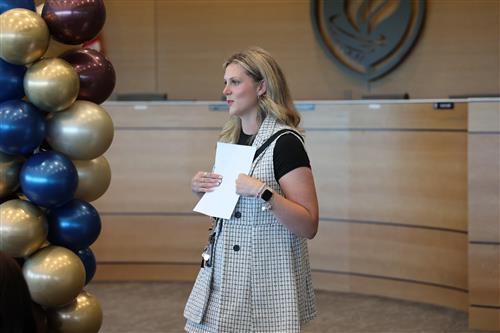 A woman holds a piece of paper