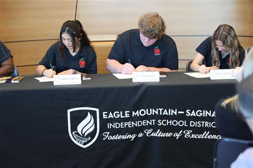 students sign a piece of paper