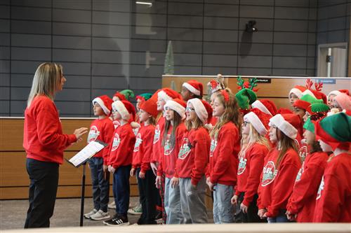 Students in Christmas attire singing