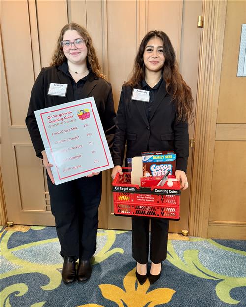 Two girls holding lesson materials in professional dress