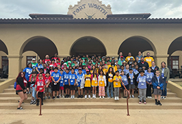  Students stand in front of the Fort Worth Livestock Exchange Building