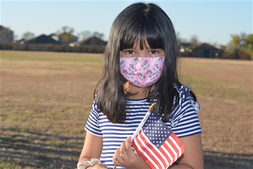 A student holds a flag at Bryson elementary 