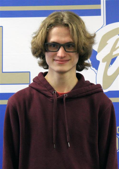 A boy with glasses and a maroon hooded sweatshirt