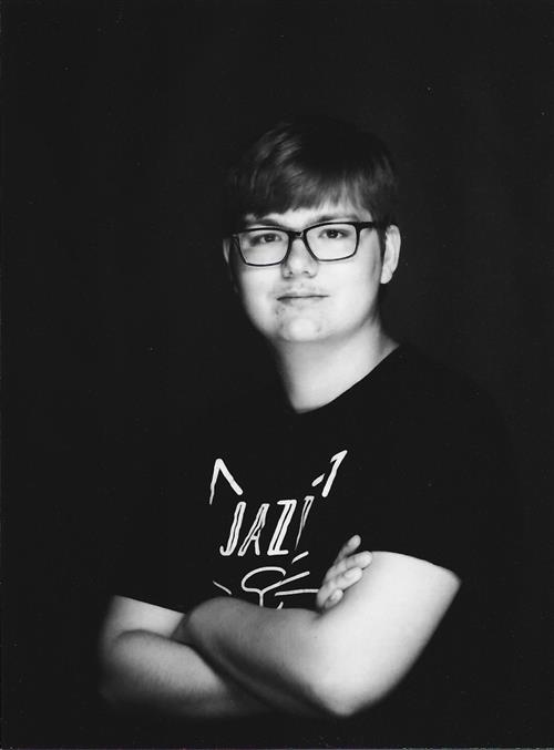 A black and white photo of a boy in his late teens