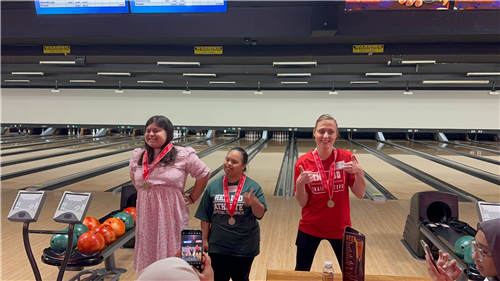 Students show off medal from Special Olympics Bowling