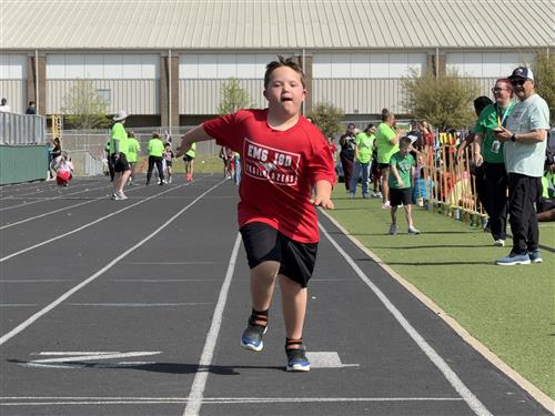 A boy runs on a track
