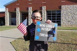 A Student Holds a Flag at Greenfield Elementary 