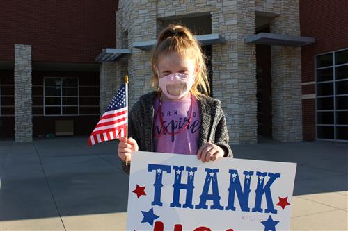 A Student Holds a Flag at Greenfield Elementary 