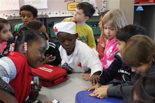 students look at a CPR dummy