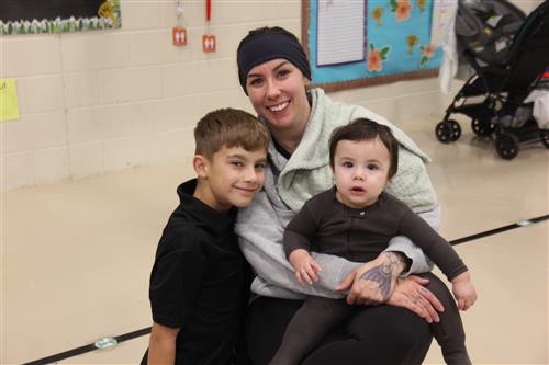 A woman with a boy and a baby
