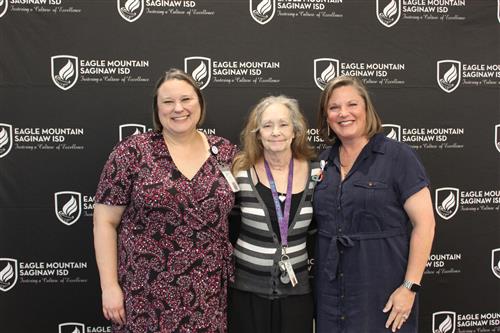 a group of women stand together