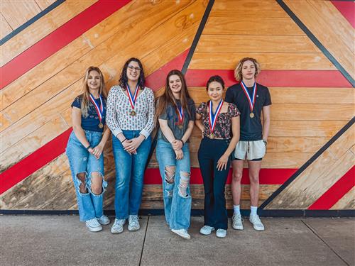Students in a row with medals