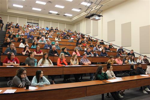 People fill a large lecture hall