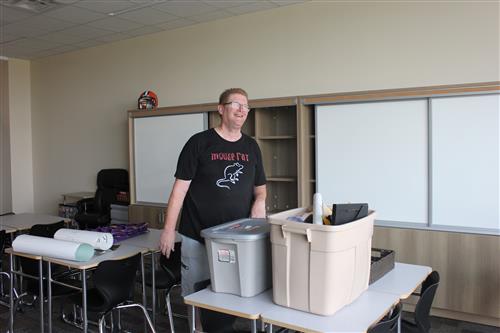 a man smiles as he unpacks