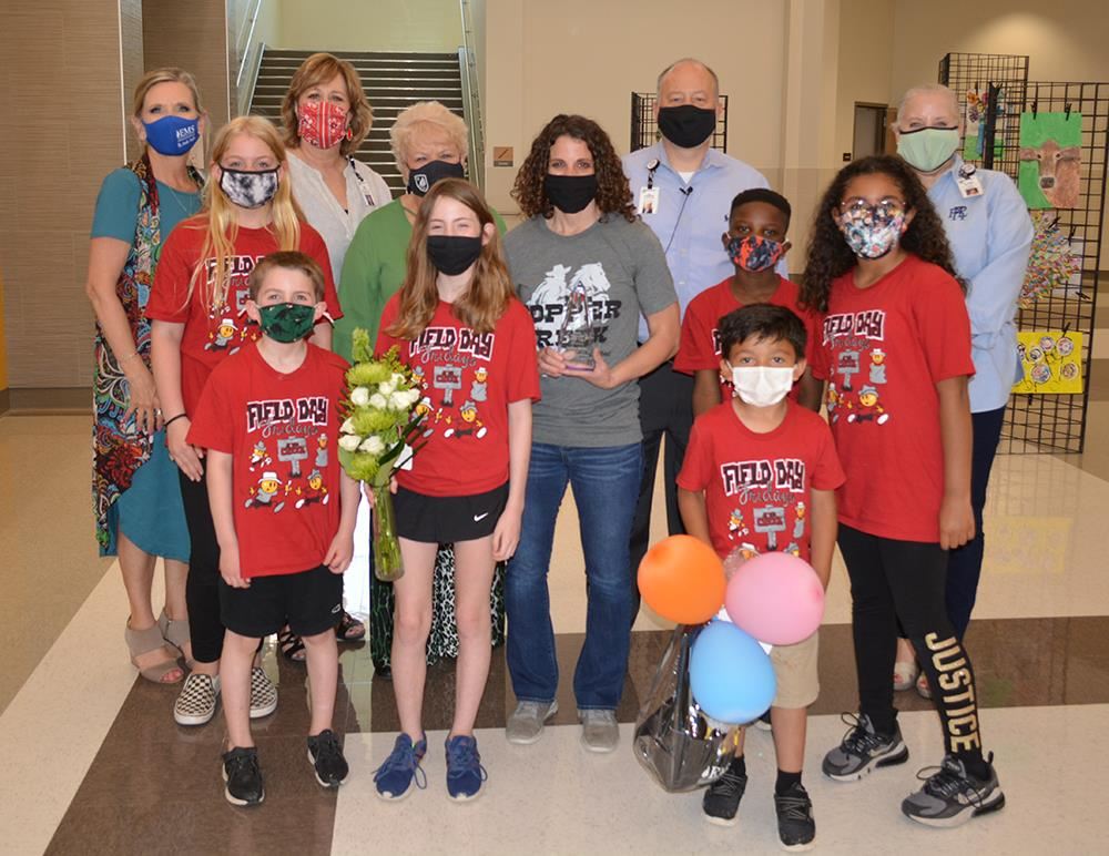 Photo of the professional of the year and administrative leaders inside an elementary school