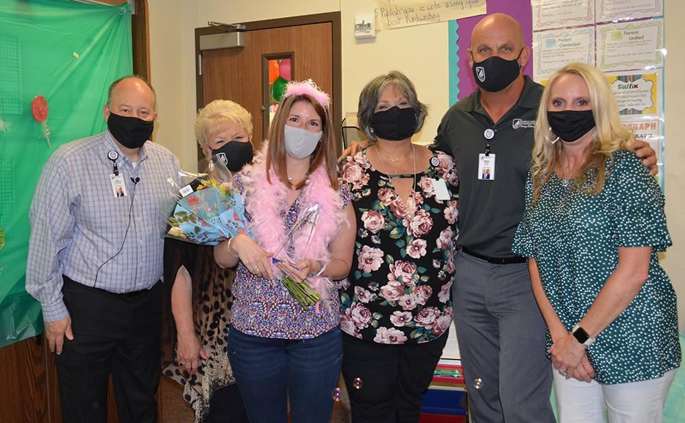 Photo of elementary teacher of the year and administrative leaders inside an elementary classroom