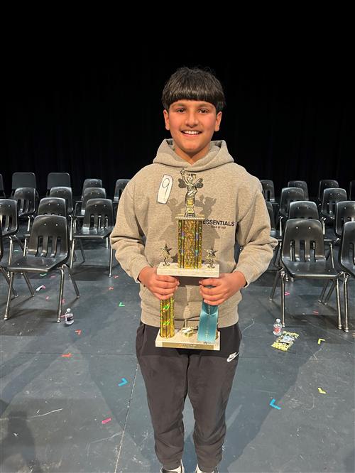 A boy holds a trophy