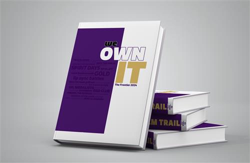 a purple and white book that says We Own It