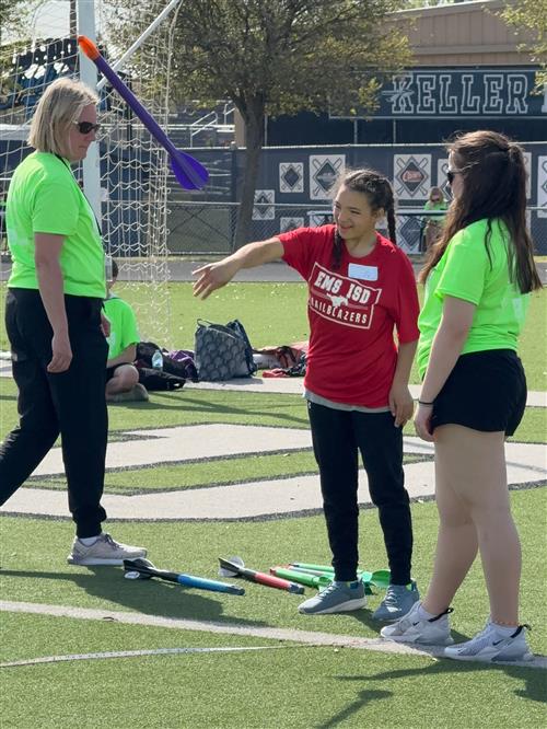 A girl throws a mini javelin
