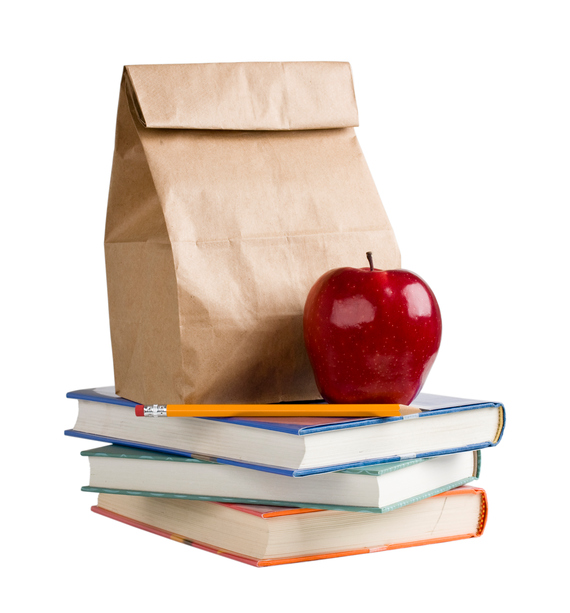 Photo of paper bag with apple on top of books