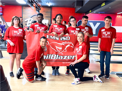 a group of students holding an EMS ISD TrailBlazers banner