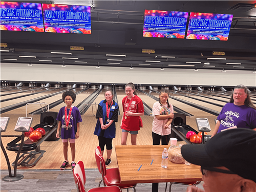 Students show off their medial from Special Olympics bowling