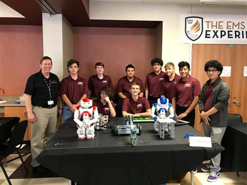 Robotics poses with their robots at Taste of Northwest. 