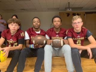 four SHS football players pose for the camera
