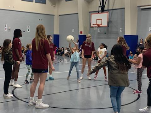 SHS volleyball players teacher students at Gililland elementary how to set the ball
