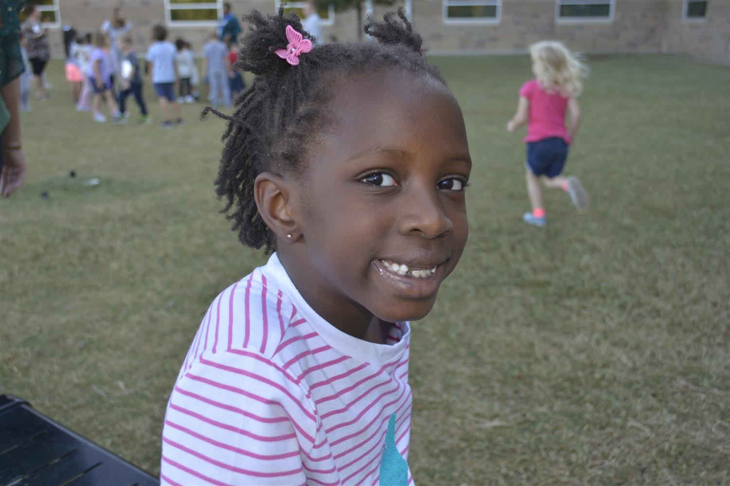 Kindergartener smiles outside