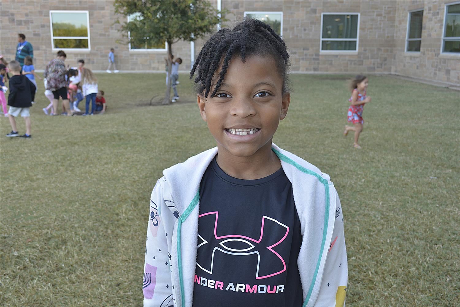 Kindergartener smiles outside