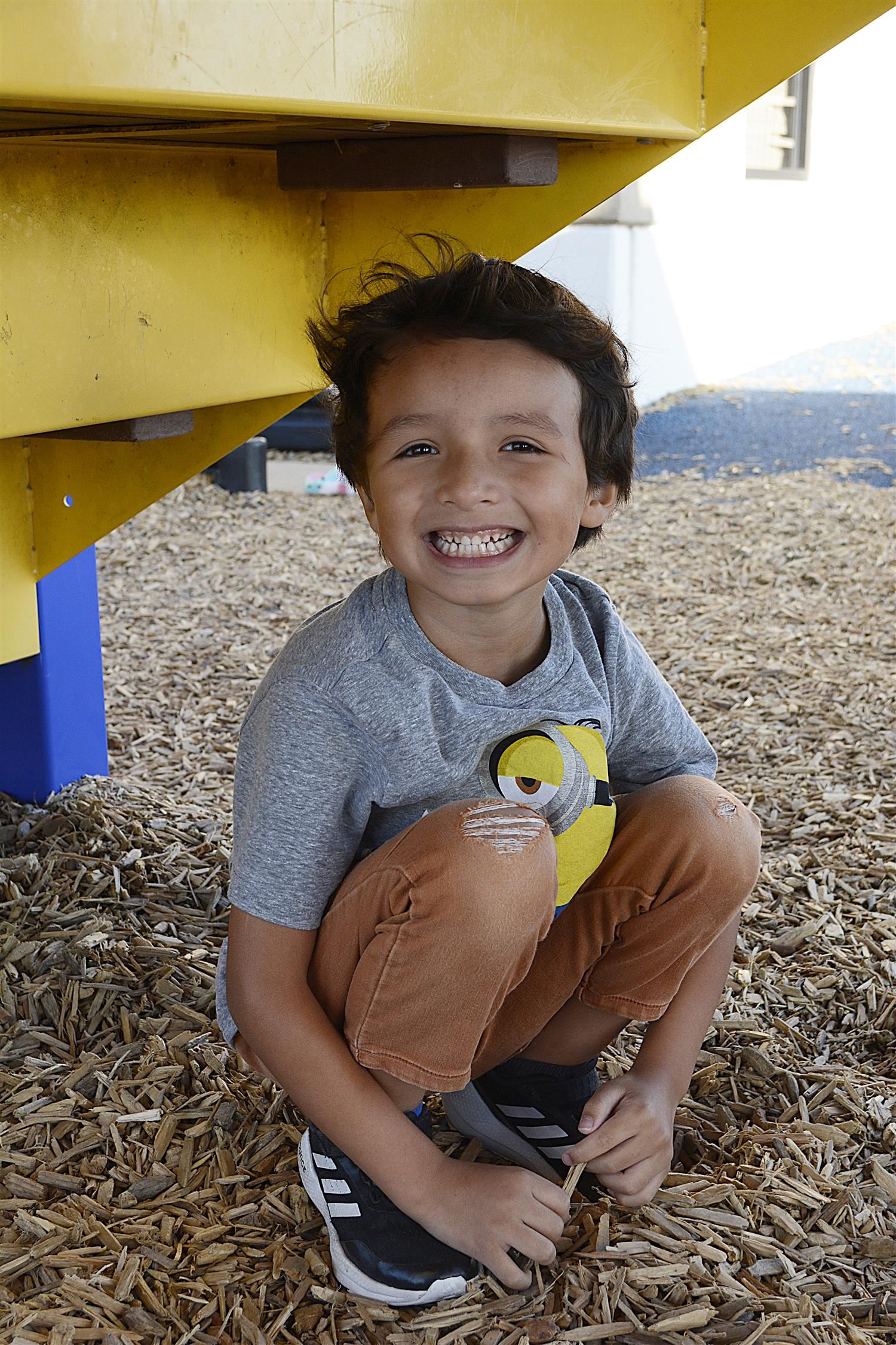 Kindergartener smiles outside