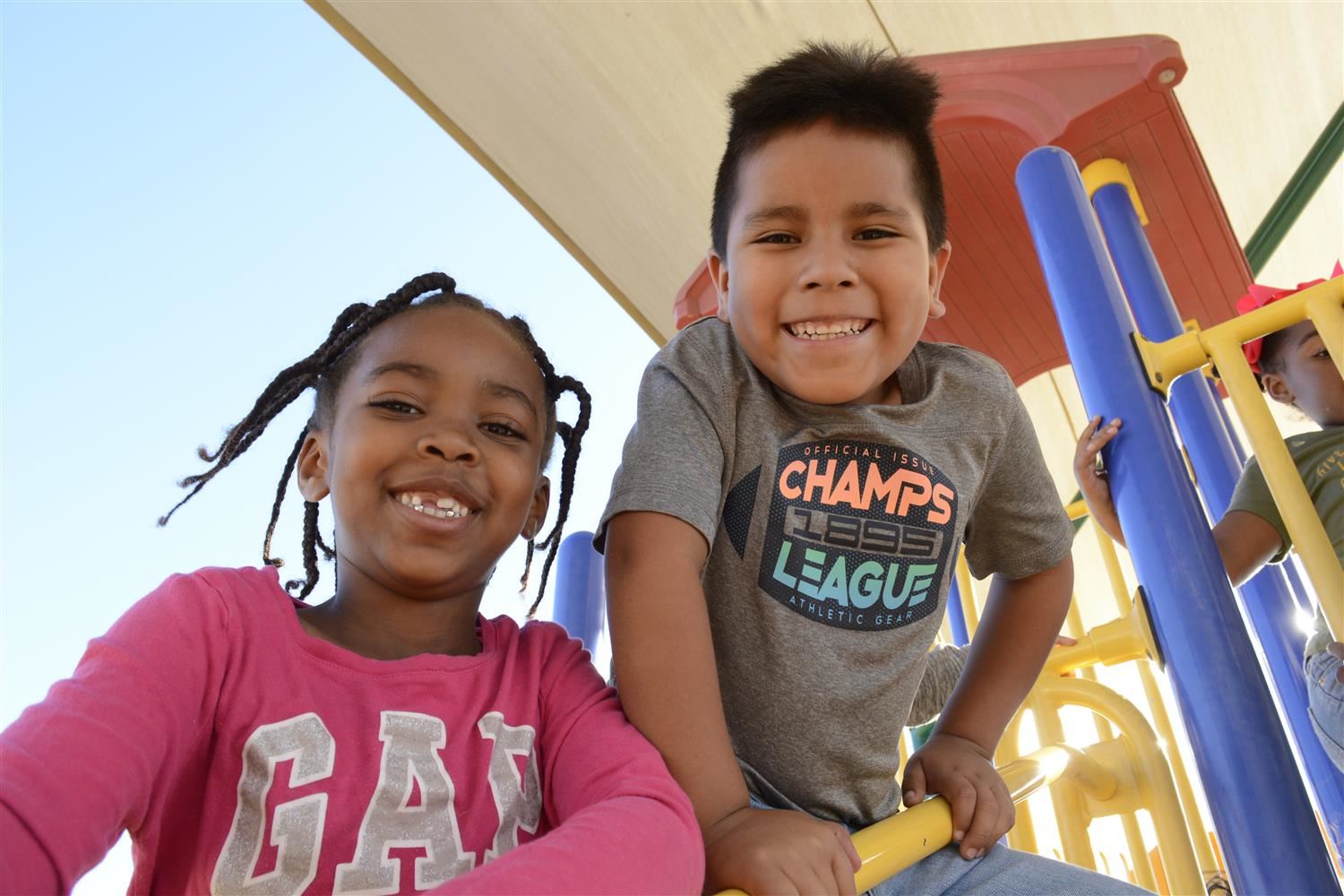 Kindergarteners smile outside