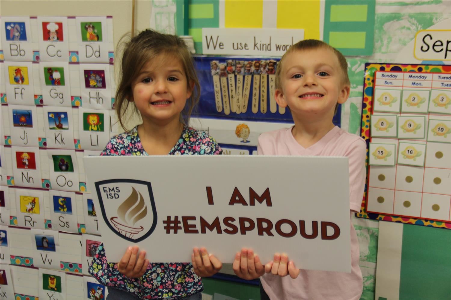 Students holding a sign saying #EMSProud