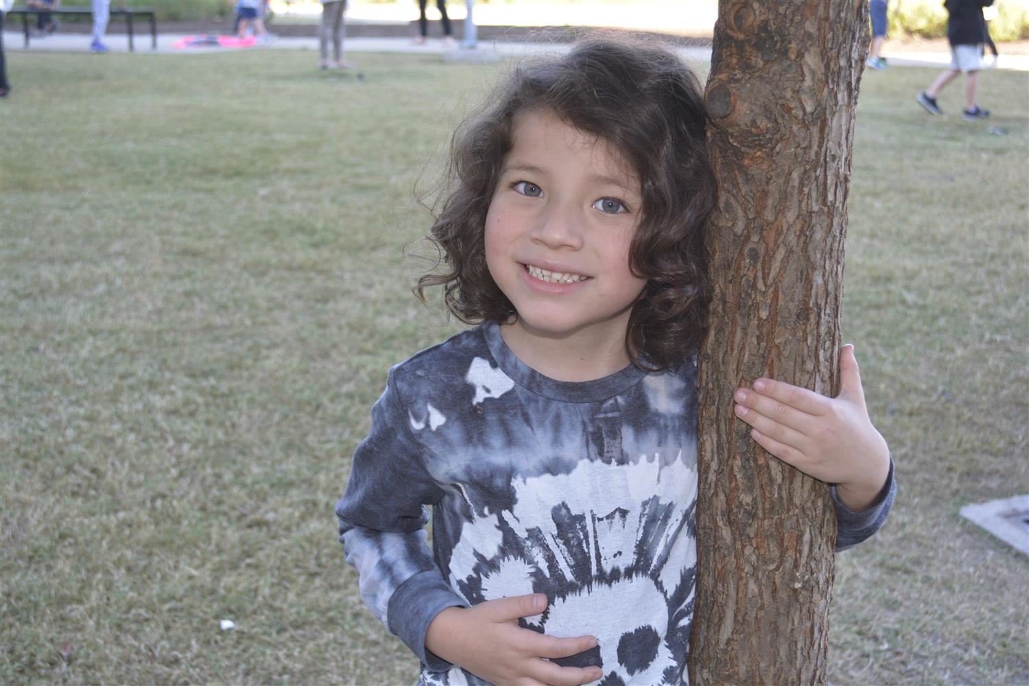 Kindergartener smiles outside