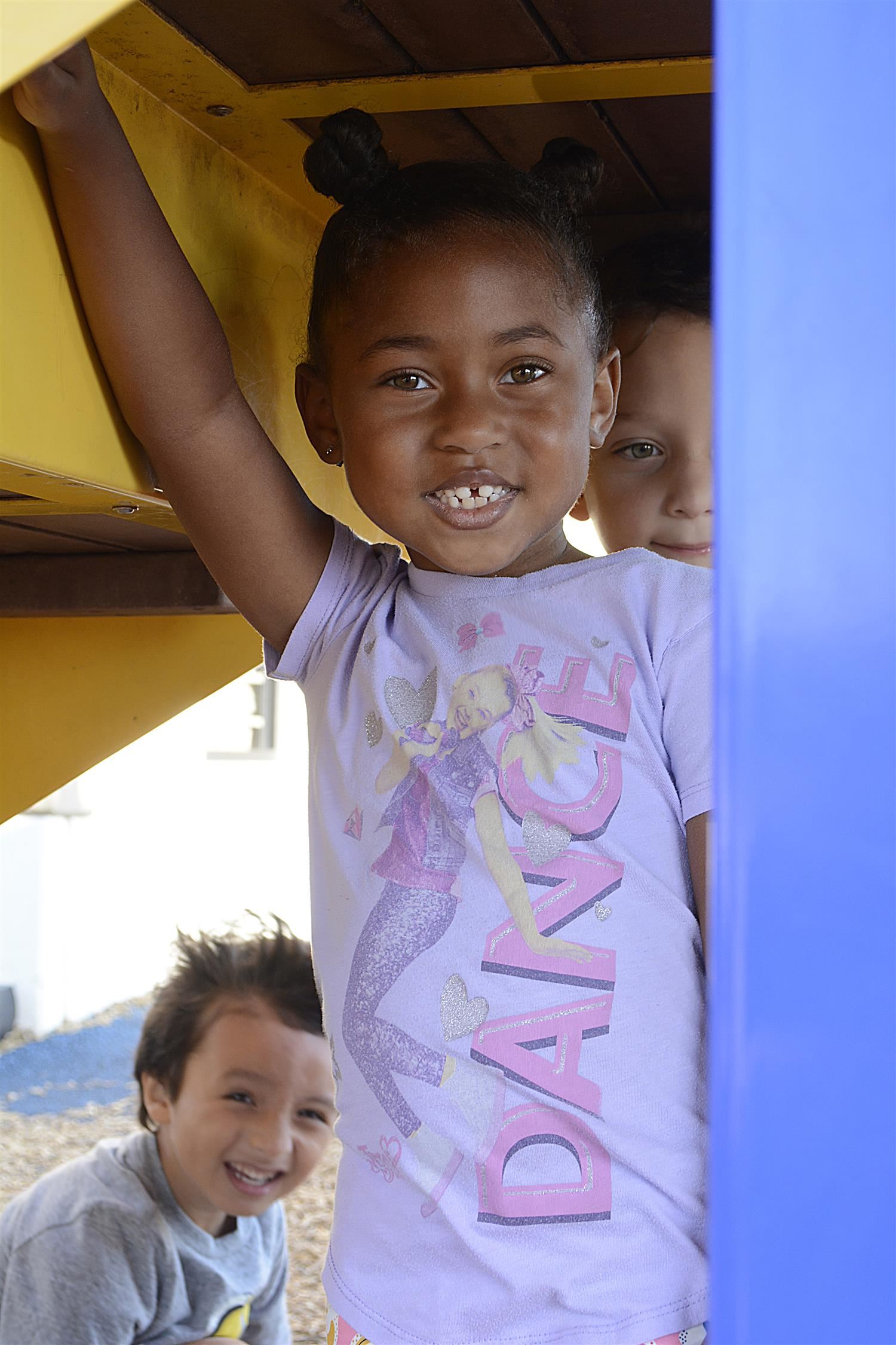 Kindergarteners smile outside