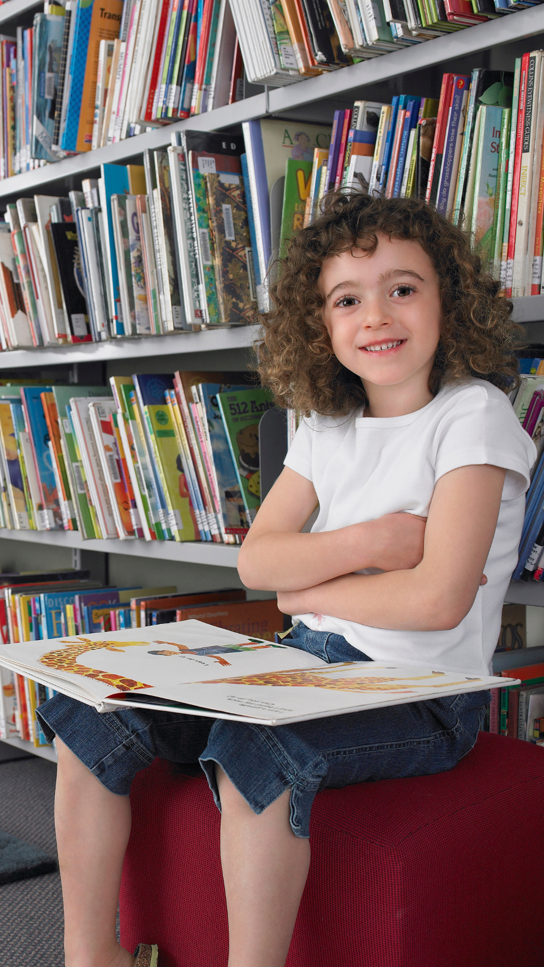 student reading a picture book in the library