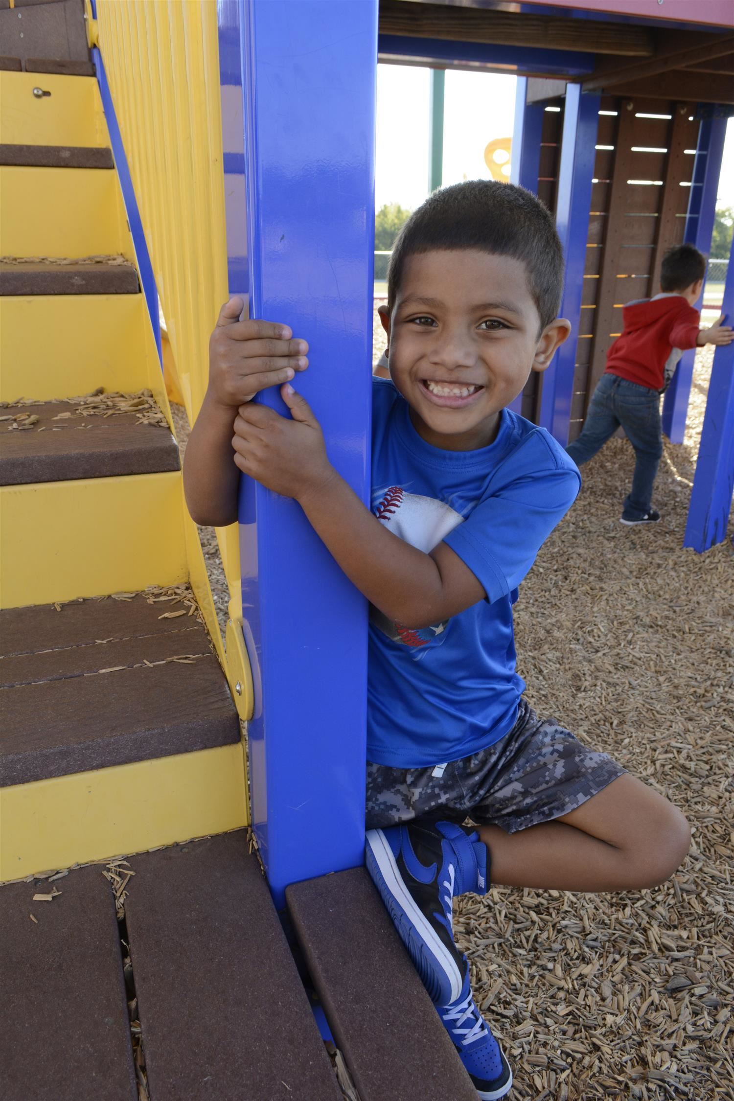 Kindergartener smiles outside