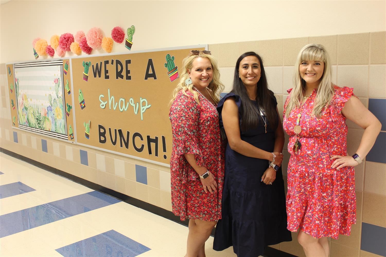 2nd grade teachers pose in the hallway during meet the teacher