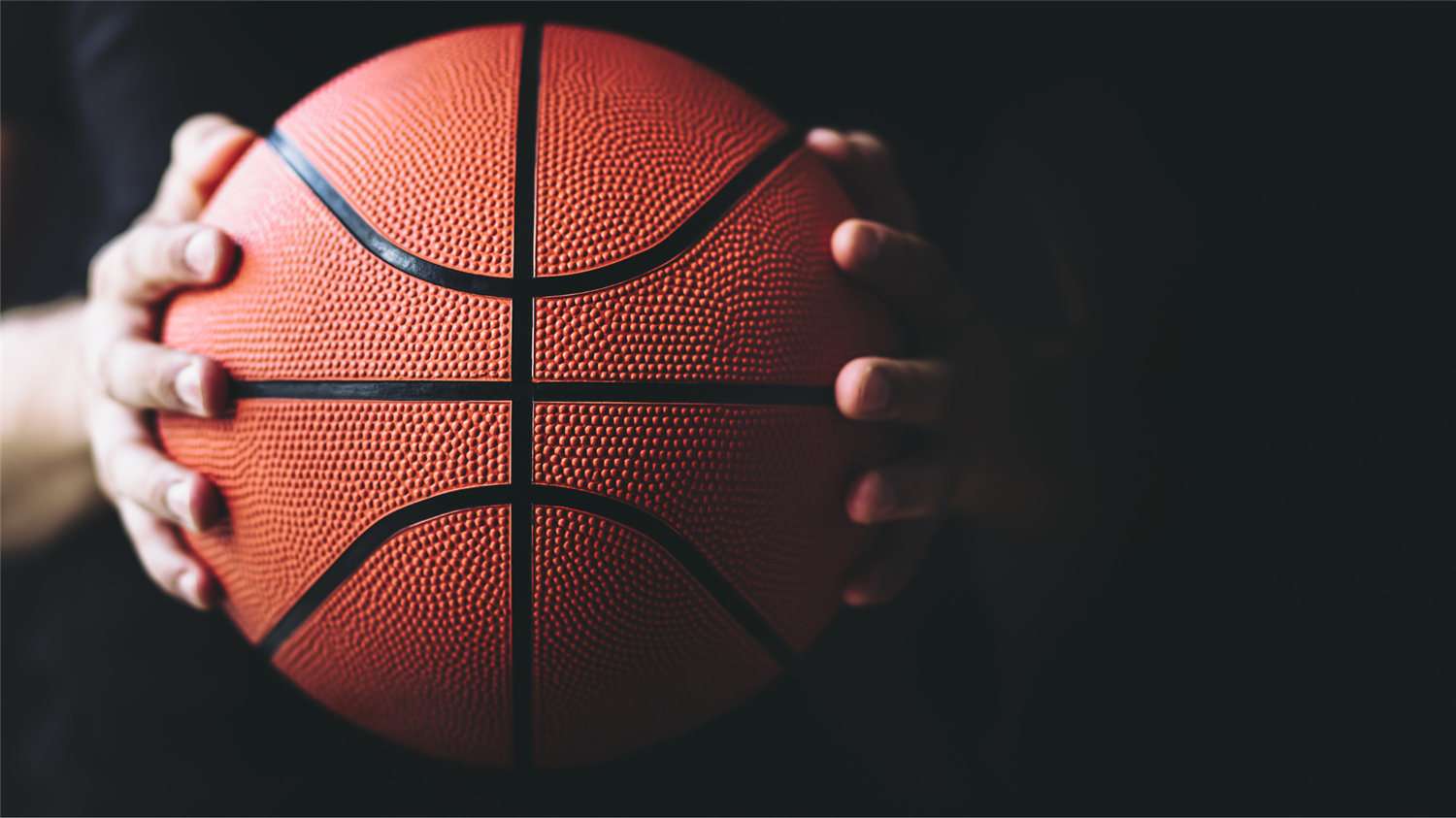 hands holding a basketball
