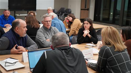 Group of adults talking at table